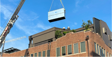 Rooftop air unit installation with a crane on top of Pittco building